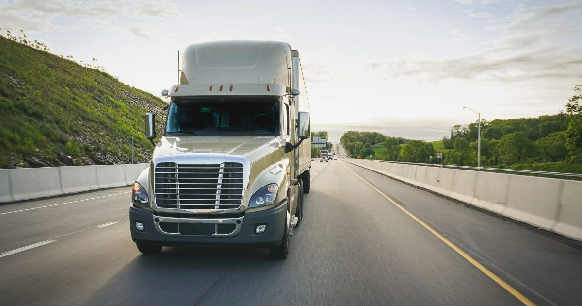 white semi truck driving aggresively during day time highlighting the risk of truck accidents